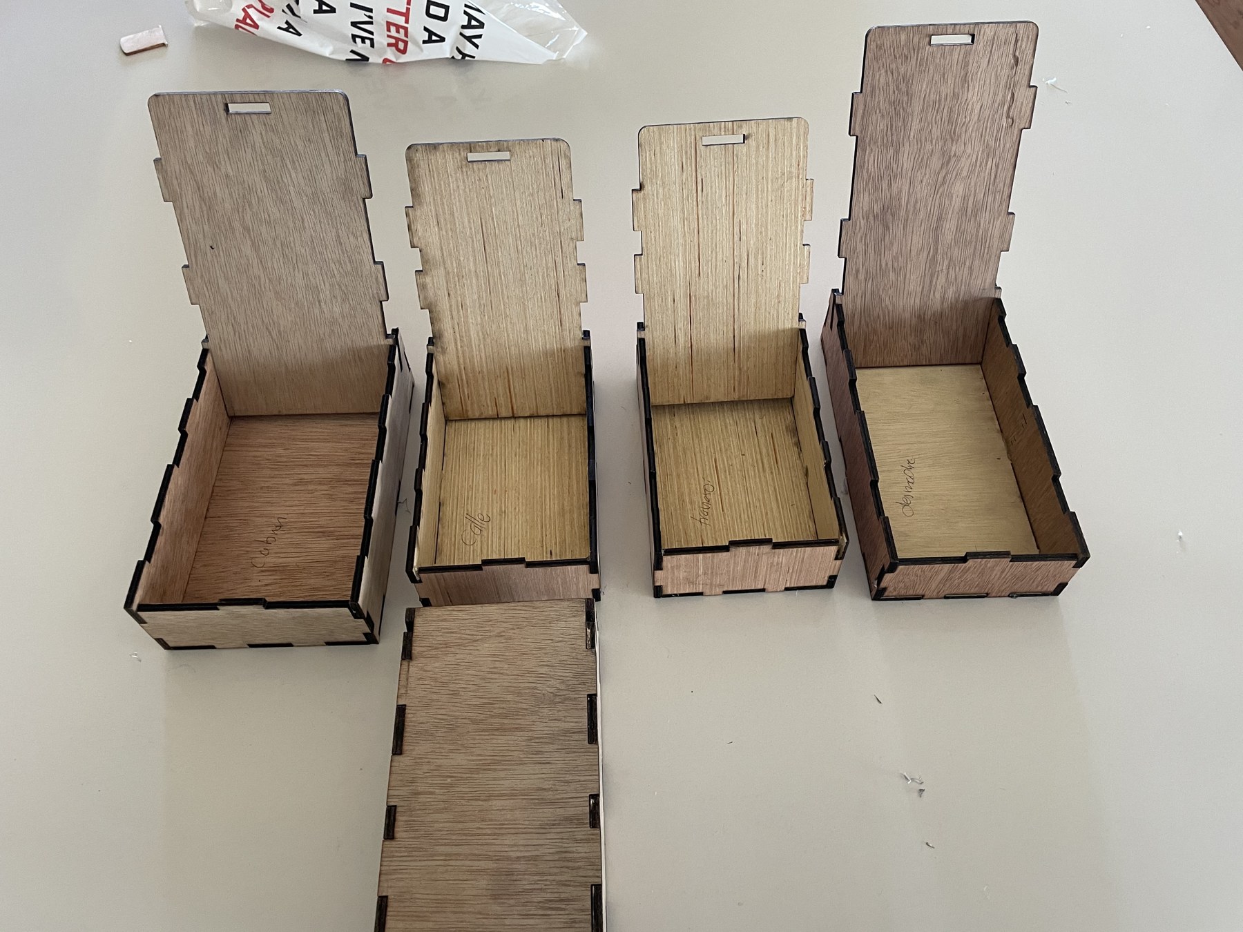 Raw wood prototype boxes, hand-labeled